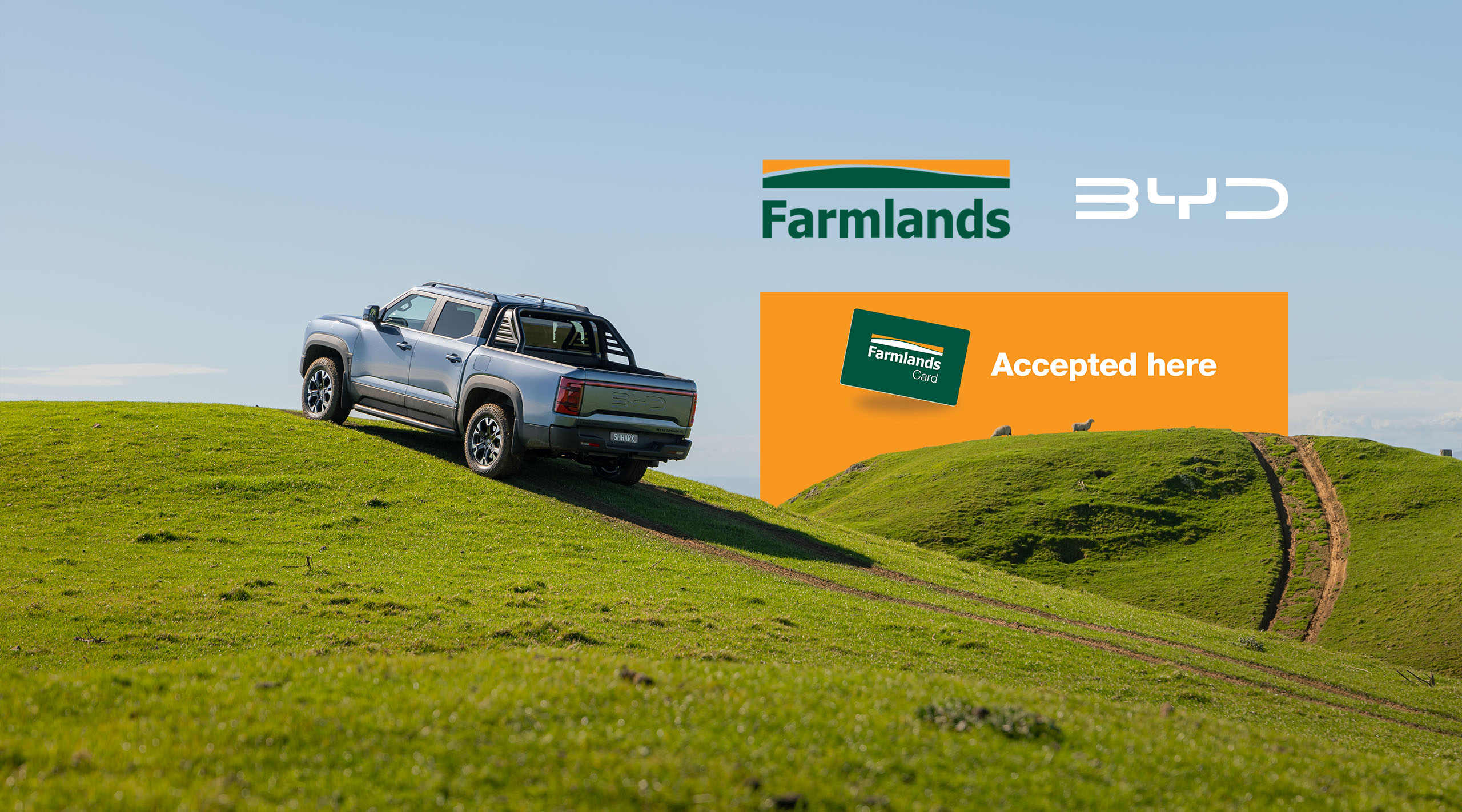 BYD Shark 6 on farm hill with Farmlands and BYD logos overlayed