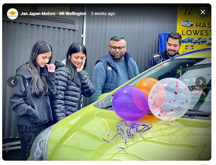 Happy customer receiving car keys at Jan Japan Motors, symbolizing affordable car financing and special offers available due to New Zealand's lower OCR