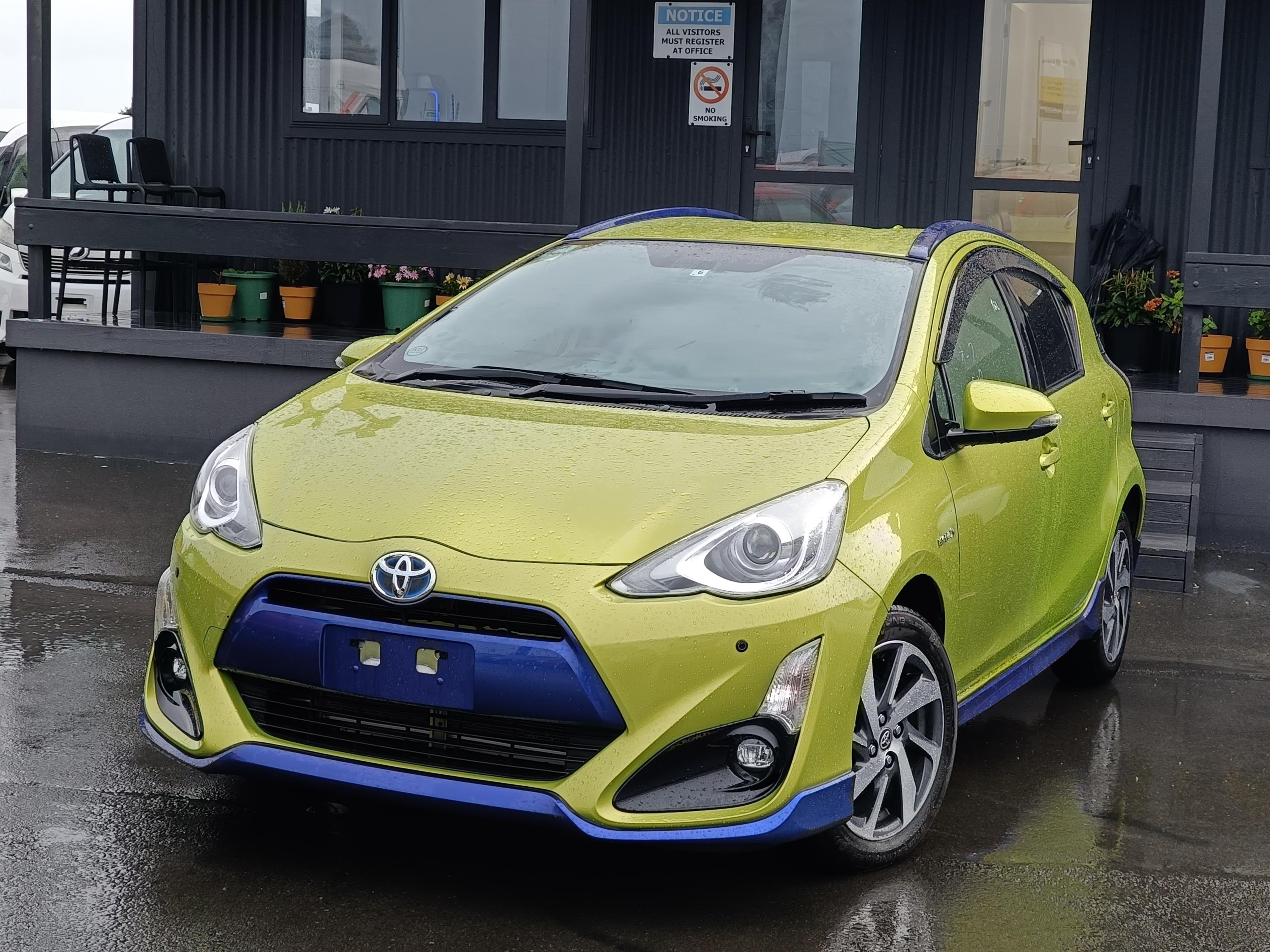 Side view of a Toyota Aqua in pristine condition, highlighting its sleek design and excellent maintenance.